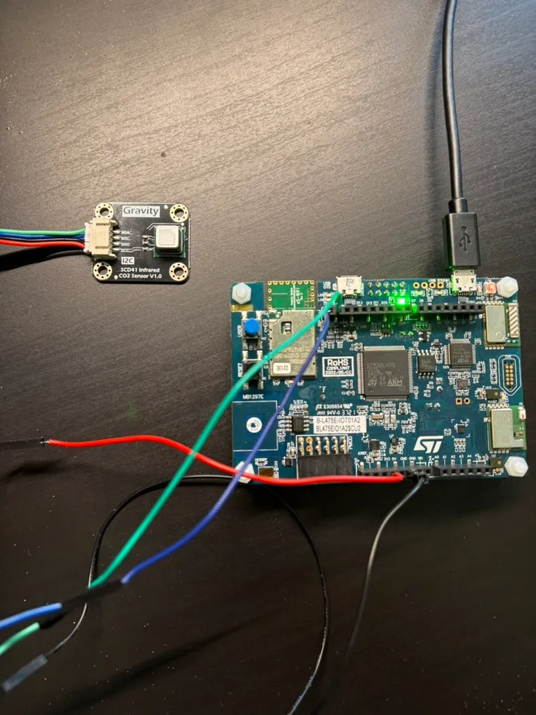 STM32 B-L475E-IOT01A2 board wired to an SCD4x CO2 sensor module for the indoor climate device slice