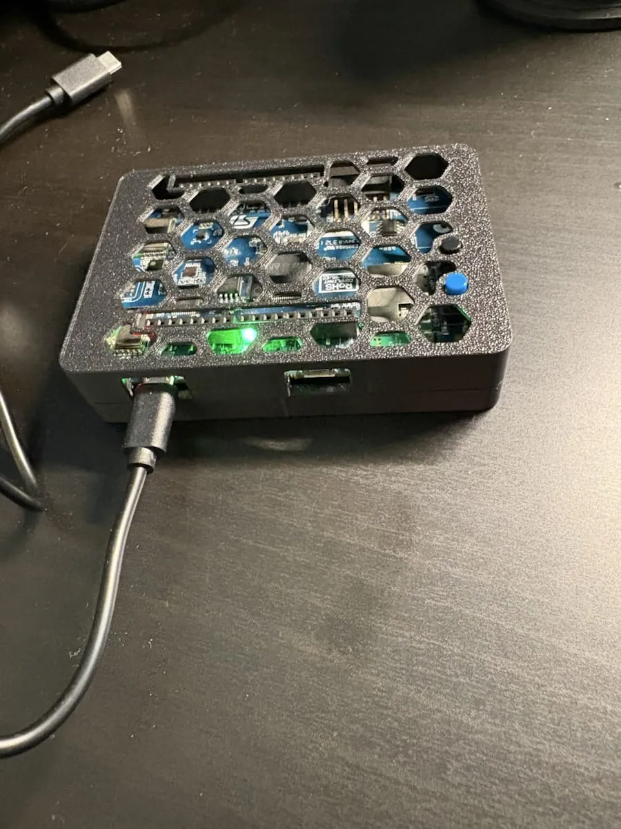 Assembled 3D printed plastic enclosure around the STM32 B-L475E-IOT01A2 field device with a large vent pattern across the top